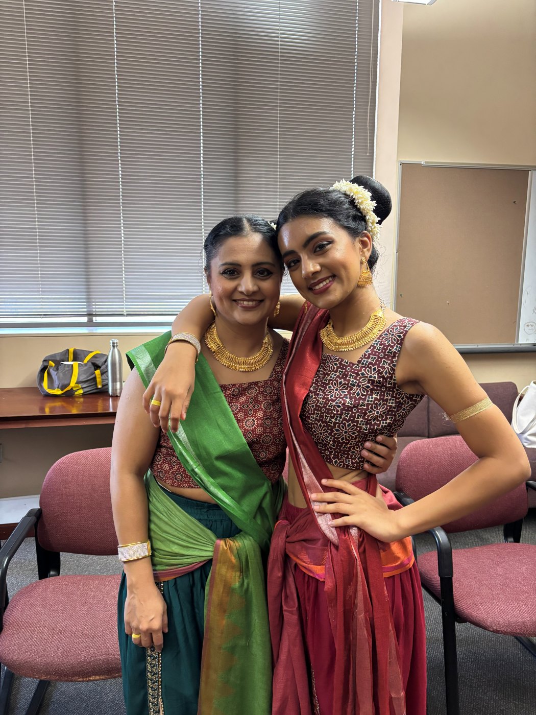 Neti hugging her mom backstage in costume
