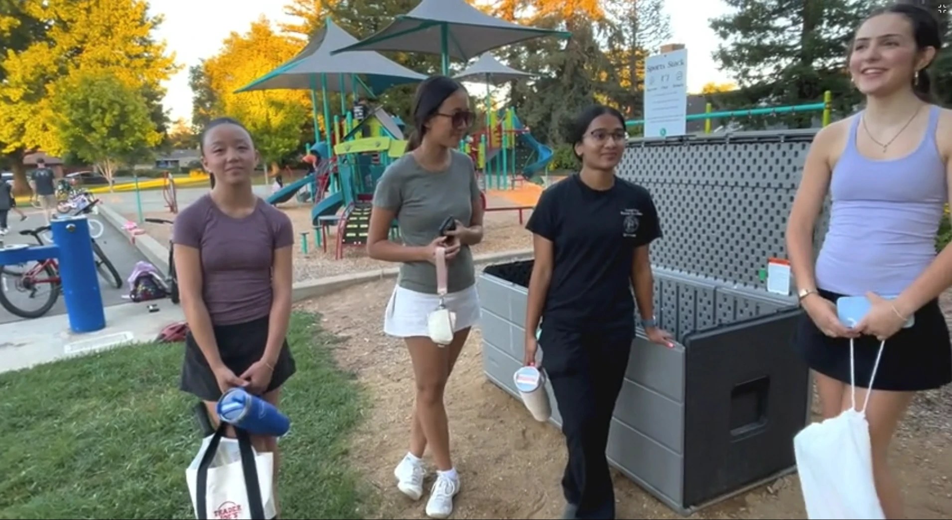 Teens talking about Sports Stack next to the box