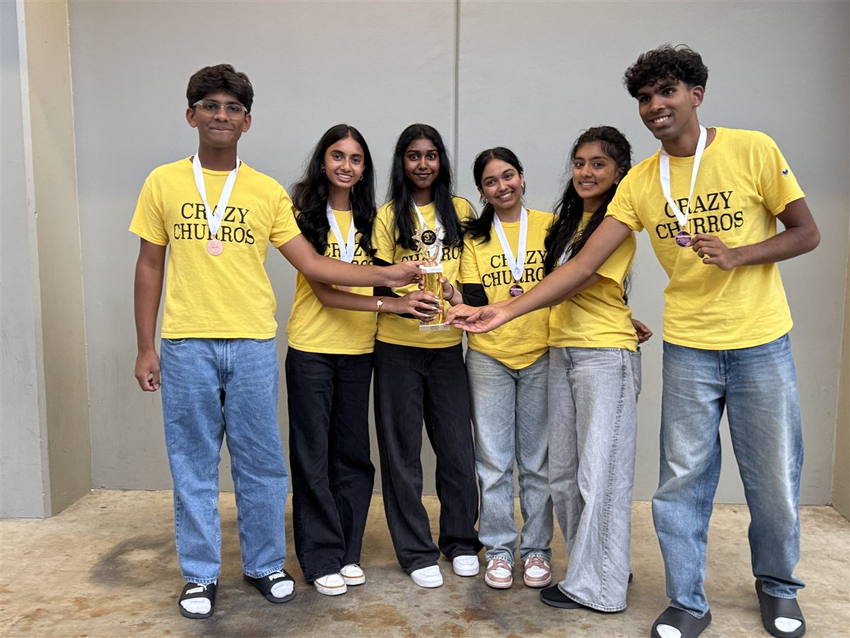 DI teammates posing with a trophy